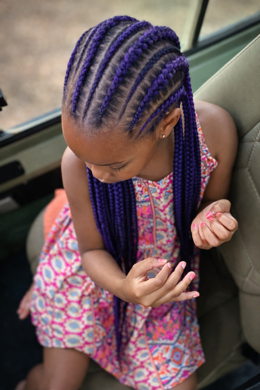 Young girl with purple braided cornrows