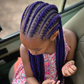 Child with purple non-toxic braided hair sitting inside a safari vehicle