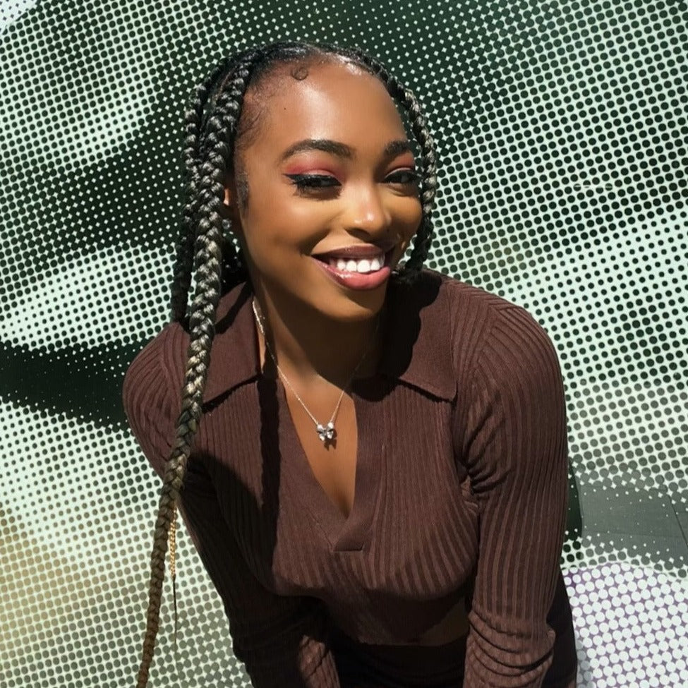 Smiling Black woman with ombre braids